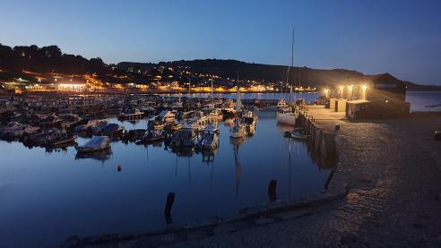 Night falls Lyme Regis harbour